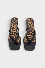 Black thong sandal mules with cheetah print insoles and kitten heels.