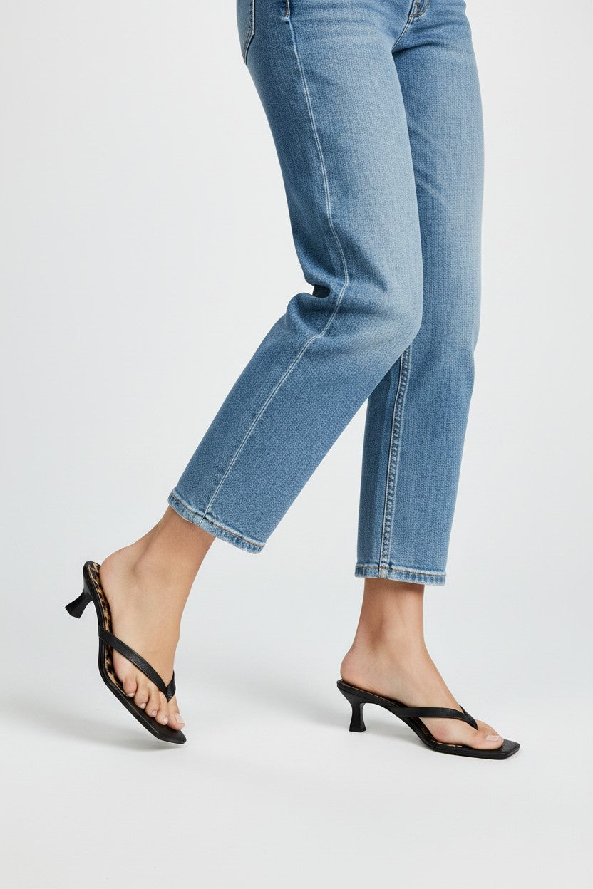 Black thong sandal mules with cheetah print insoles and kitten heels.