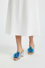 Silver slip-on sandal heels with blue silk orchid flower accents.