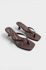 Brown thong sandal mules with snake print insoles and kitten heels.