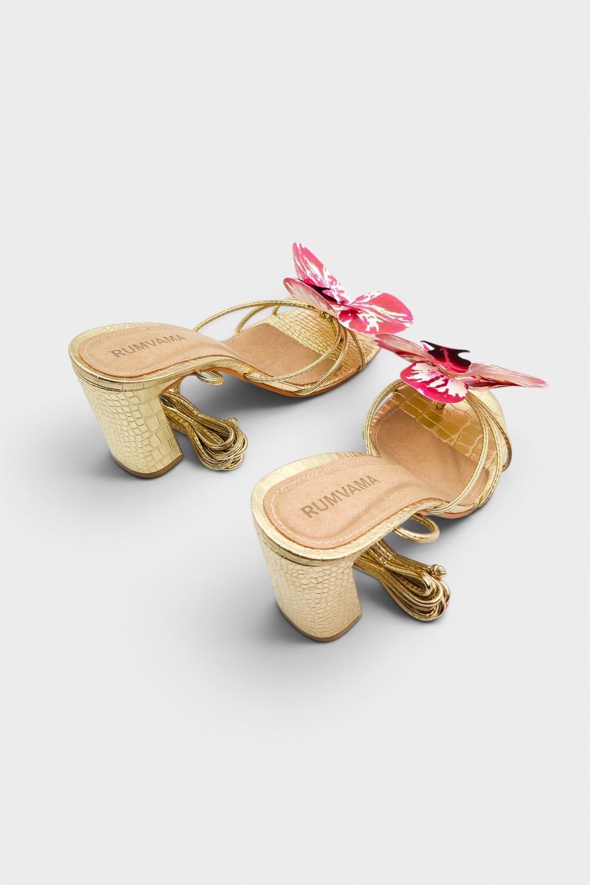 Gold slip-on sandal heels with printed orchid flower accents.