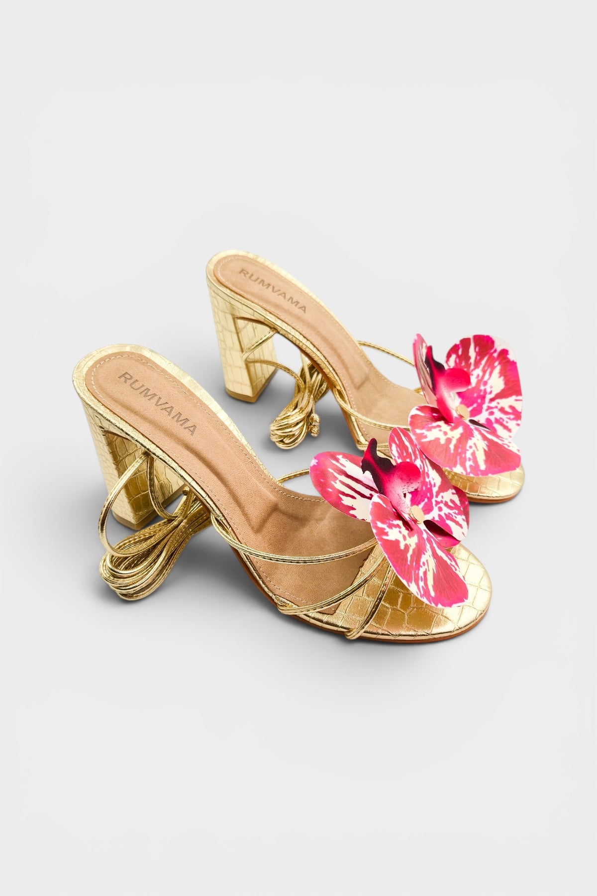 Gold slip-on sandal heels with printed orchid flower accents.
