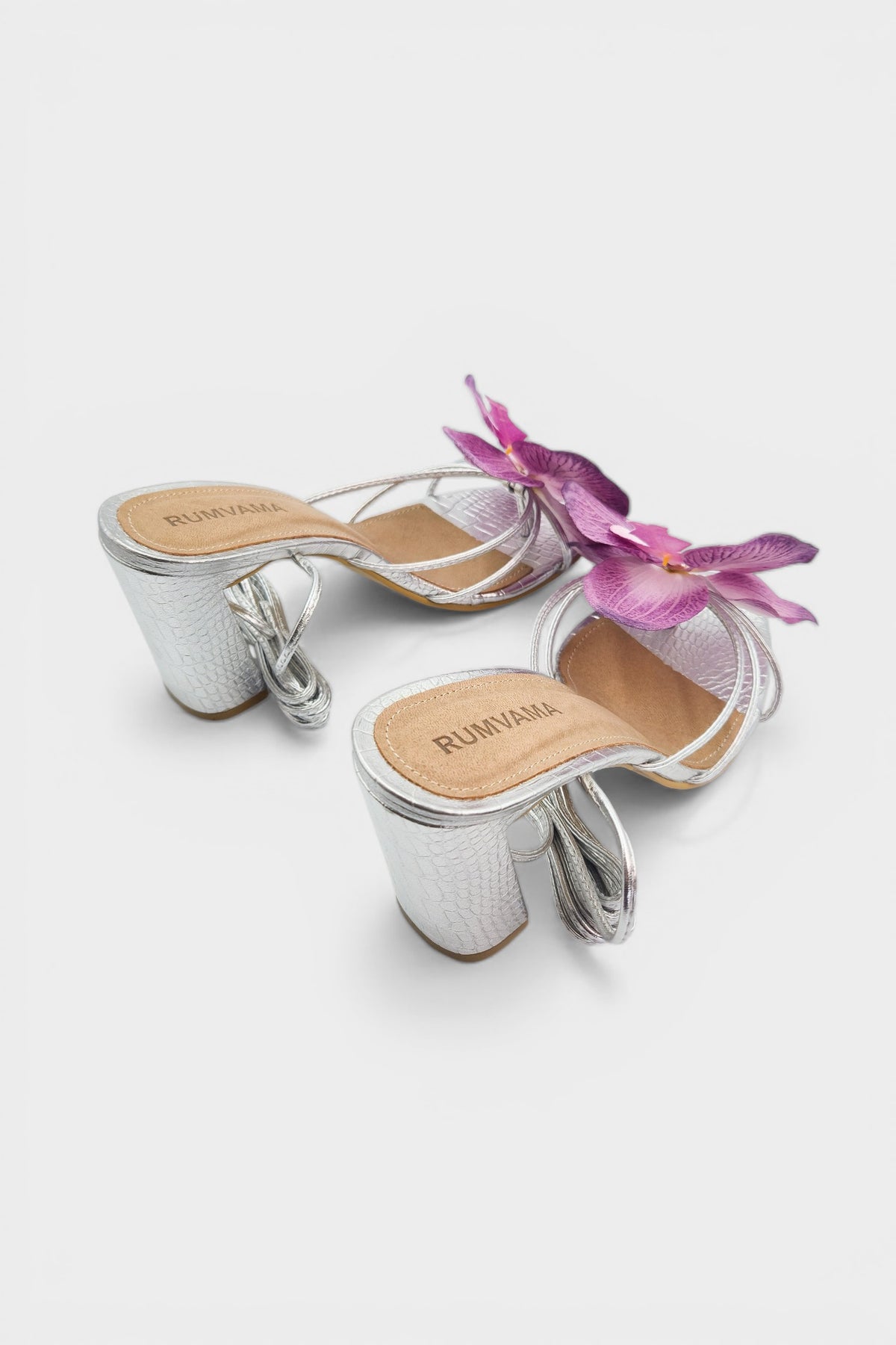 Silver slip-on sandal heels with lavender silk orchid flower accents.