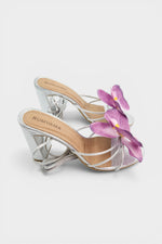 Silver slip-on sandal heels with lavender silk orchid flower accents.