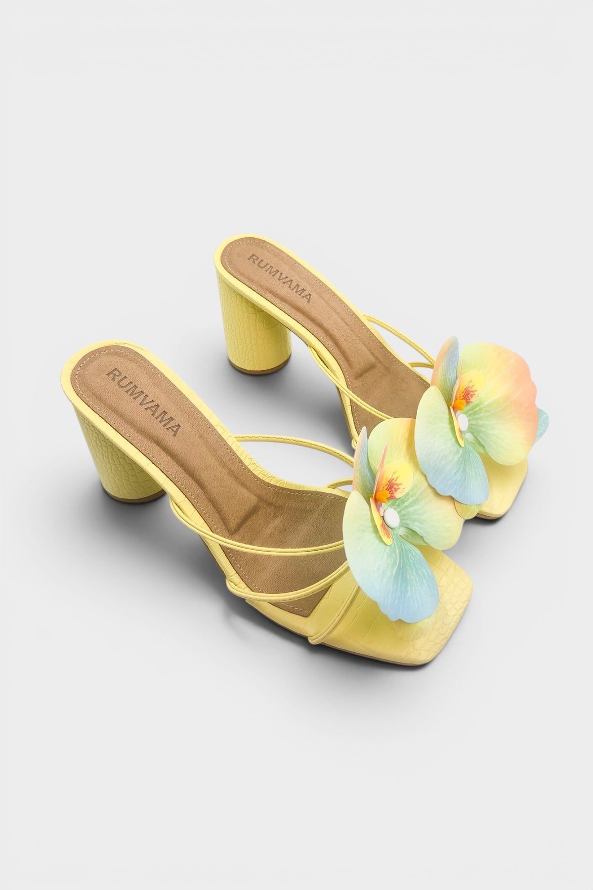 Yellow slip-on sandal heels with printed orchid flower accents.