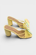 Yellow slip-on sandal heels with printed orchid flower accents.