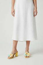 Yellow slip-on sandal heels with printed orchid flower accents.