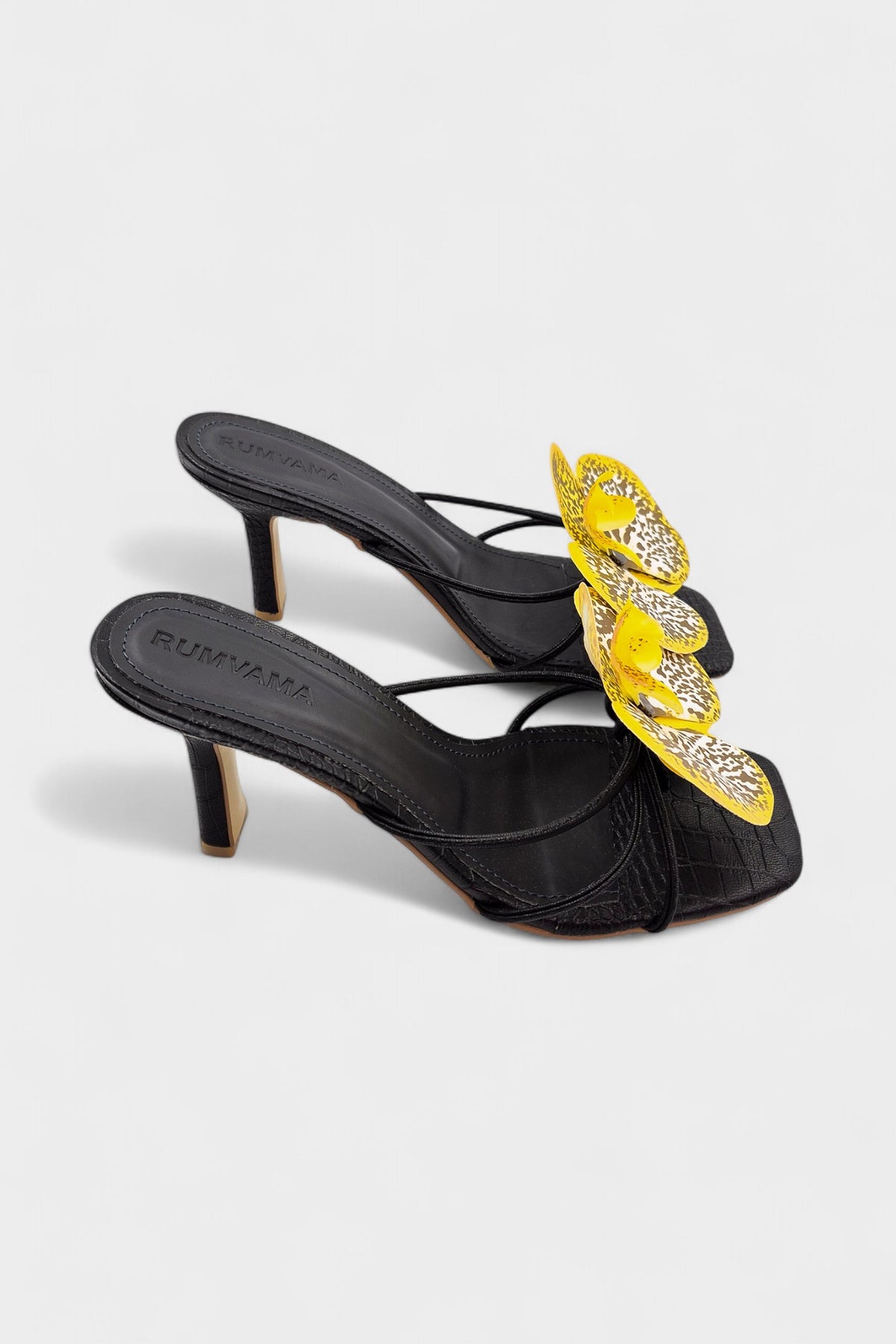 Black slip-on sandal heels with printed orchid flower accents.