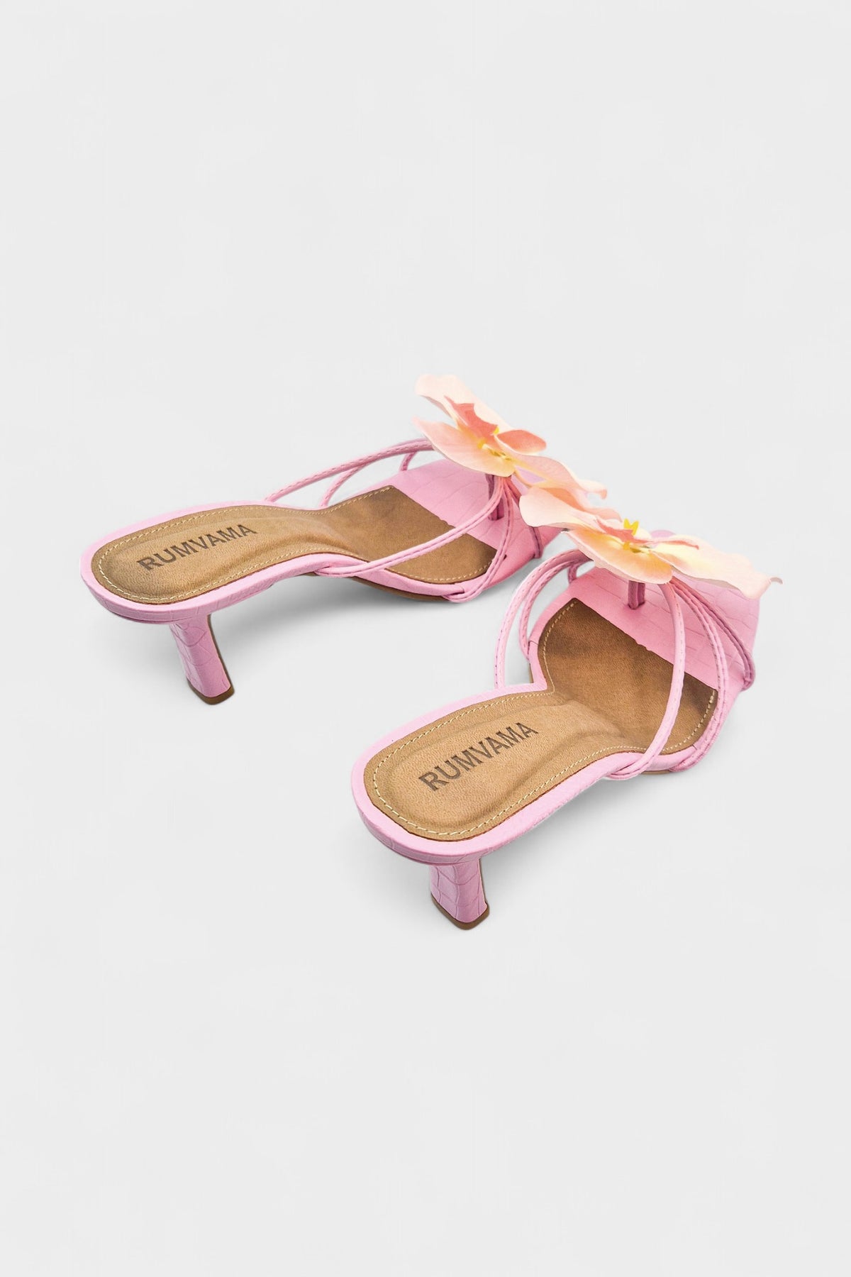 Pink slip-on sandal heels with silk orchid flower accents.
