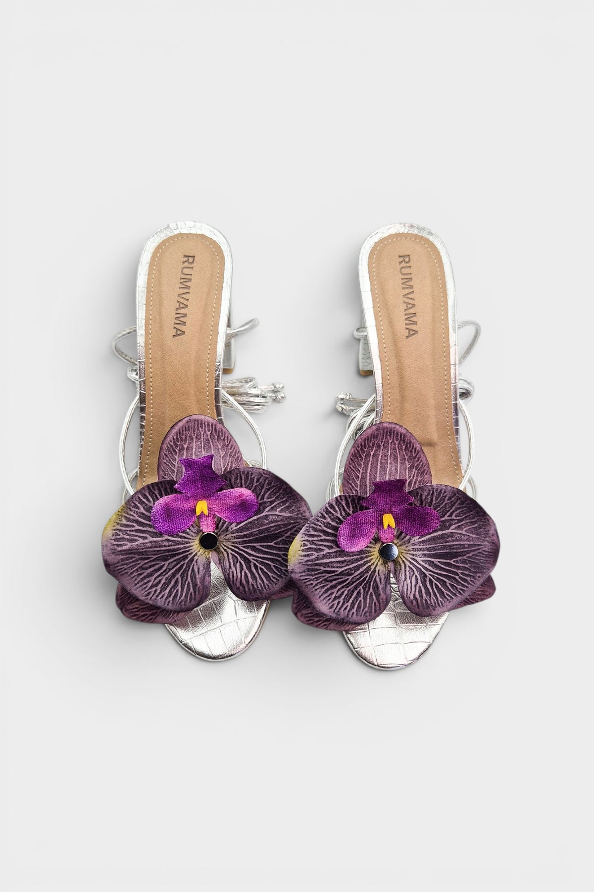 Silver slip-on sandal heels with purple silk orchid flower accents.
