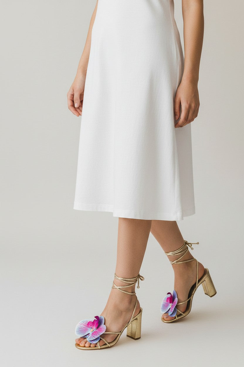 Gold slip-on sandal heels with printed orchid flower accents.