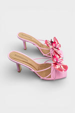 Pink slip-on sandal heels with printed orchid flower accents.