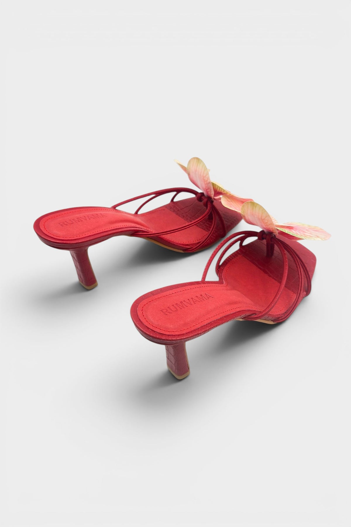 Red slip-on sandal heels with printed orchid flower accents.