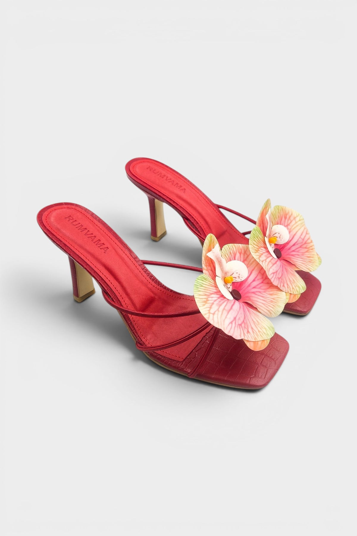 Red slip-on sandal heels with printed orchid flower accents.