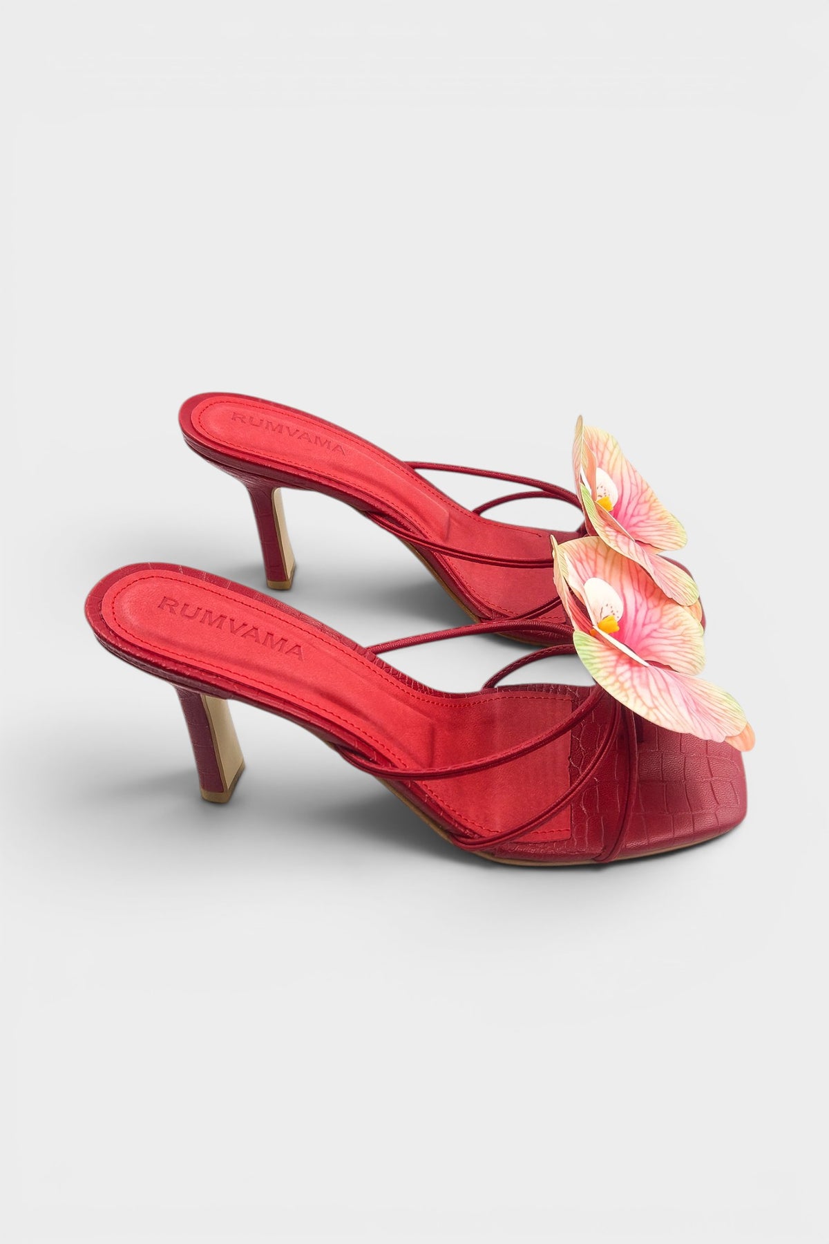 Red slip-on sandal heels with printed orchid flower accents.