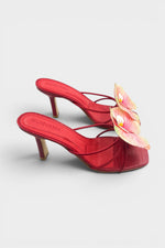 Red slip-on sandal heels with printed orchid flower accents.