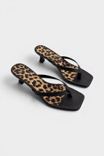 Black thong sandal mules with cheetah print insoles and kitten heels.