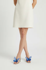 Silver slip-on sandal heels with blue silk butterfly accents.
