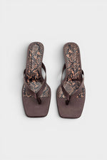 Brown thong sandal mules with snake print insoles and kitten heels.