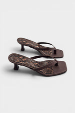Brown thong sandal mules with snake print insoles and kitten heels.