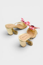 Gold slip-on sandal heels with printed orchid flower accents.