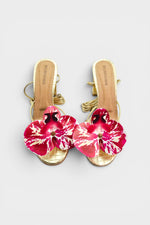 Gold slip-on sandal heels with printed orchid flower accents.