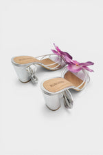 Silver slip-on sandal heels with lavender silk orchid flower accents.