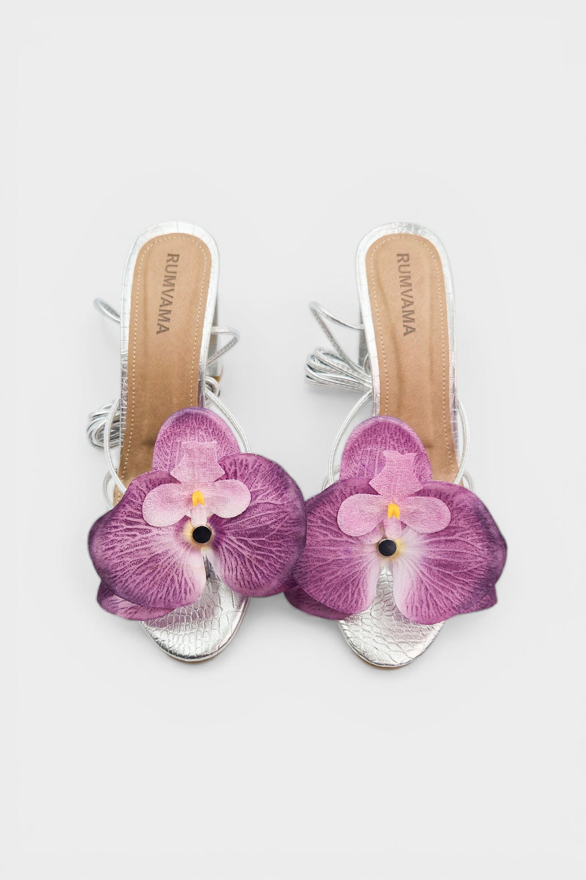 Silver slip-on sandal heels with lavender silk orchid flower accents.
