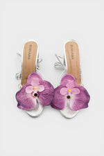 Silver slip-on sandal heels with lavender silk orchid flower accents.