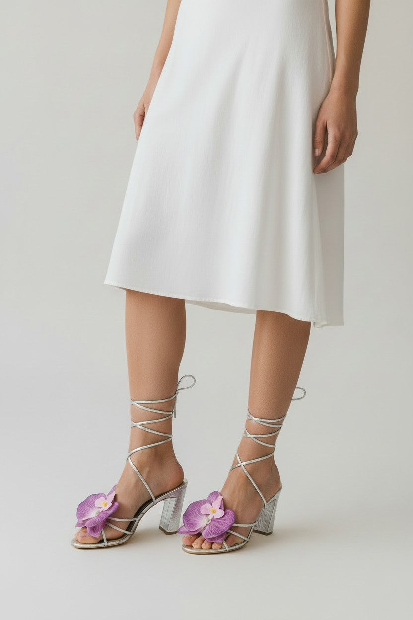 Silver slip-on sandal heels with lavender silk orchid flower accents.