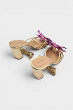 Gold slip-on sandal heels with lavender silk orchid flower accents.