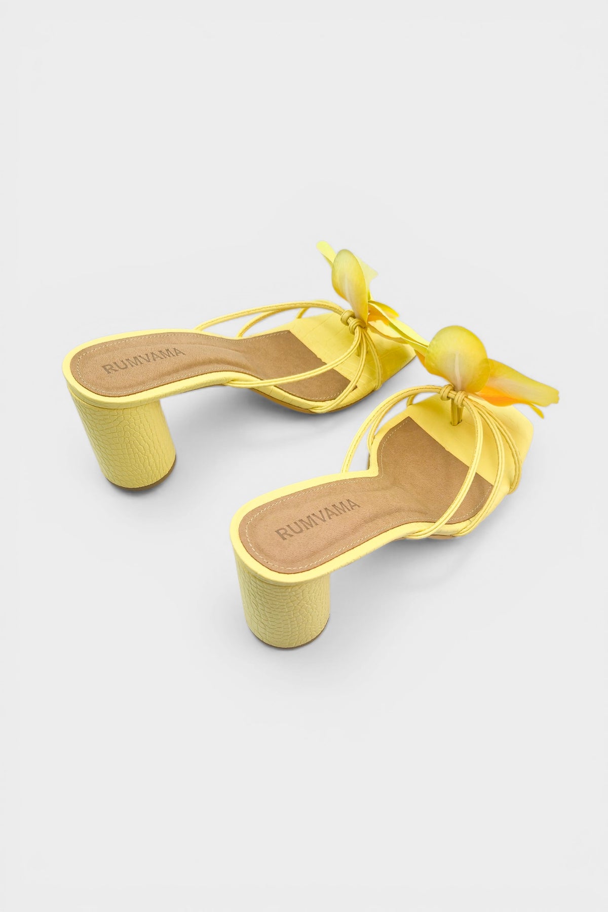 Yellow slip-on sandal heels with printed orchid flower accents.