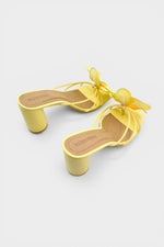 Yellow slip-on sandal heels with printed orchid flower accents.