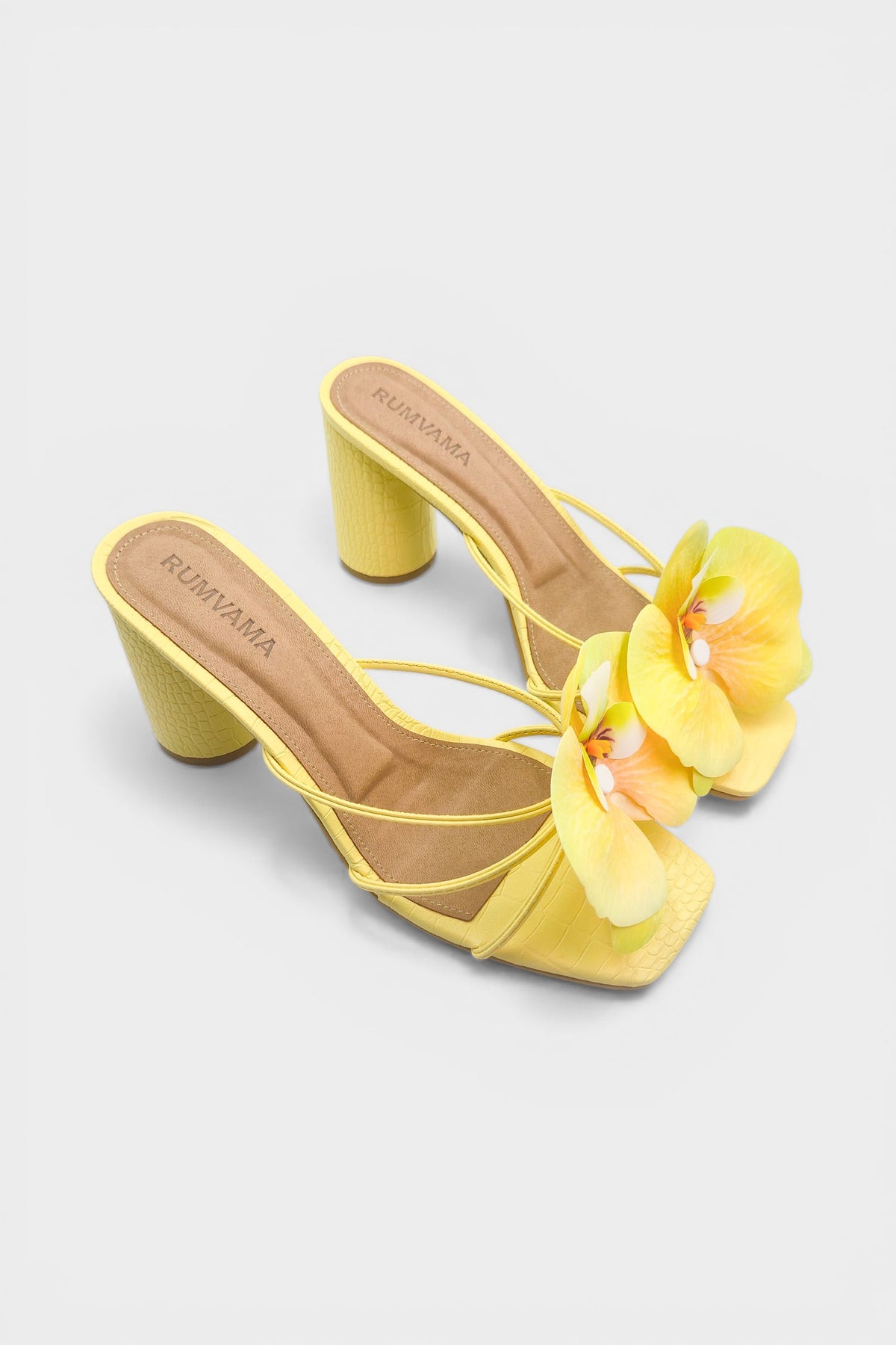 Yellow slip-on sandal heels with printed orchid flower accents.