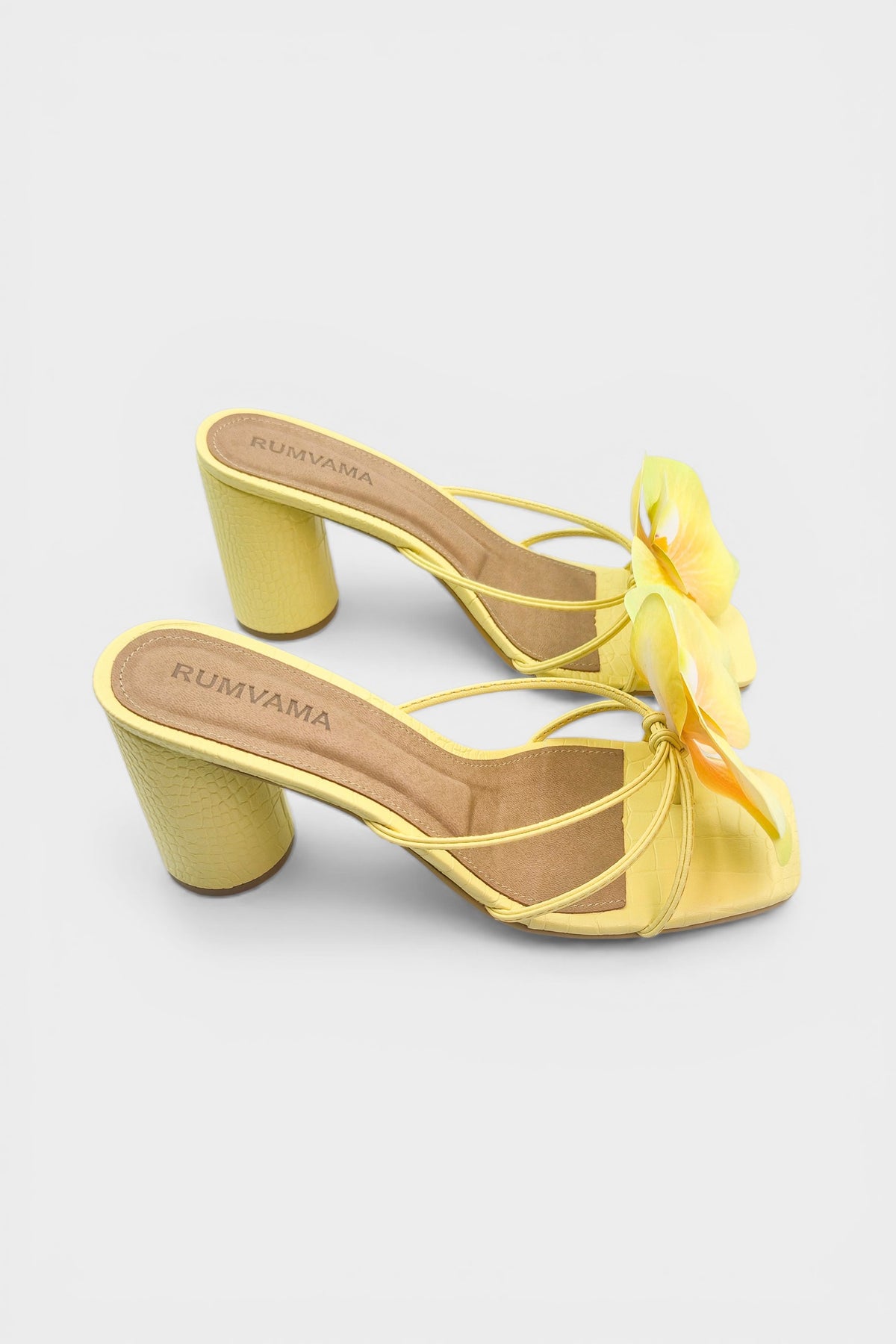 Yellow slip-on sandal heels with printed orchid flower accents.