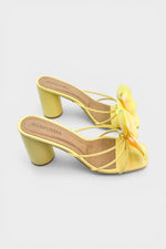 Yellow slip-on sandal heels with printed orchid flower accents.