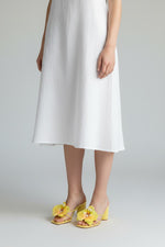 Yellow slip-on sandal heels with printed orchid flower accents.