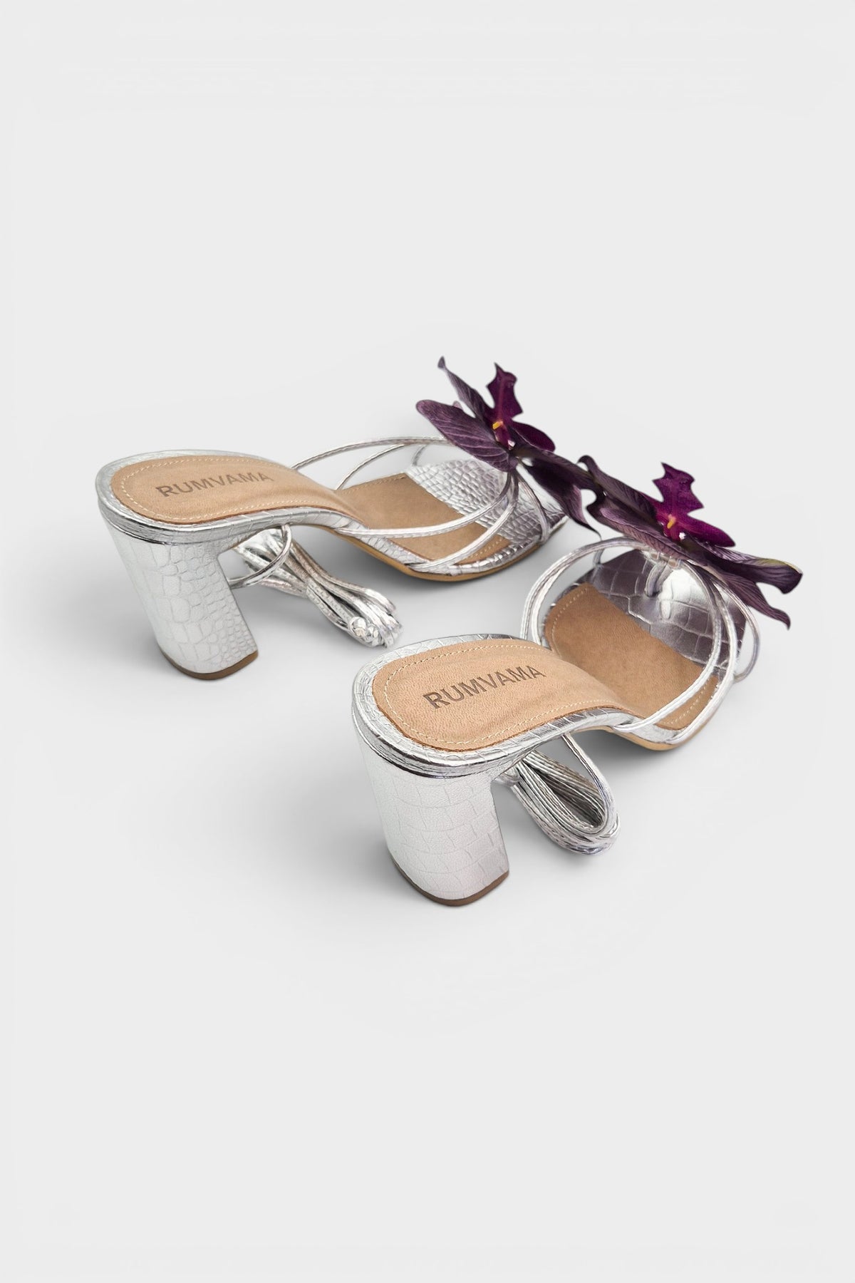 Silver slip-on sandal heels with purple silk orchid flower accents.