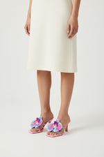 Pink slip-on sandal heels with printed orchid flower accents.