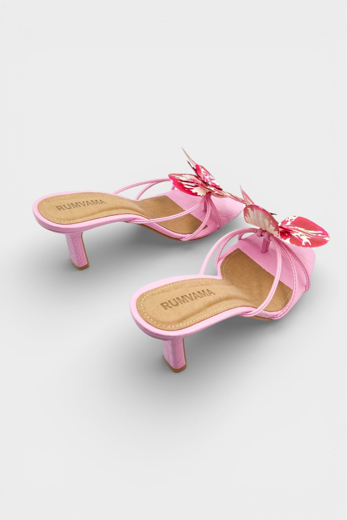 Pink slip-on sandal heels with printed orchid flower accents.