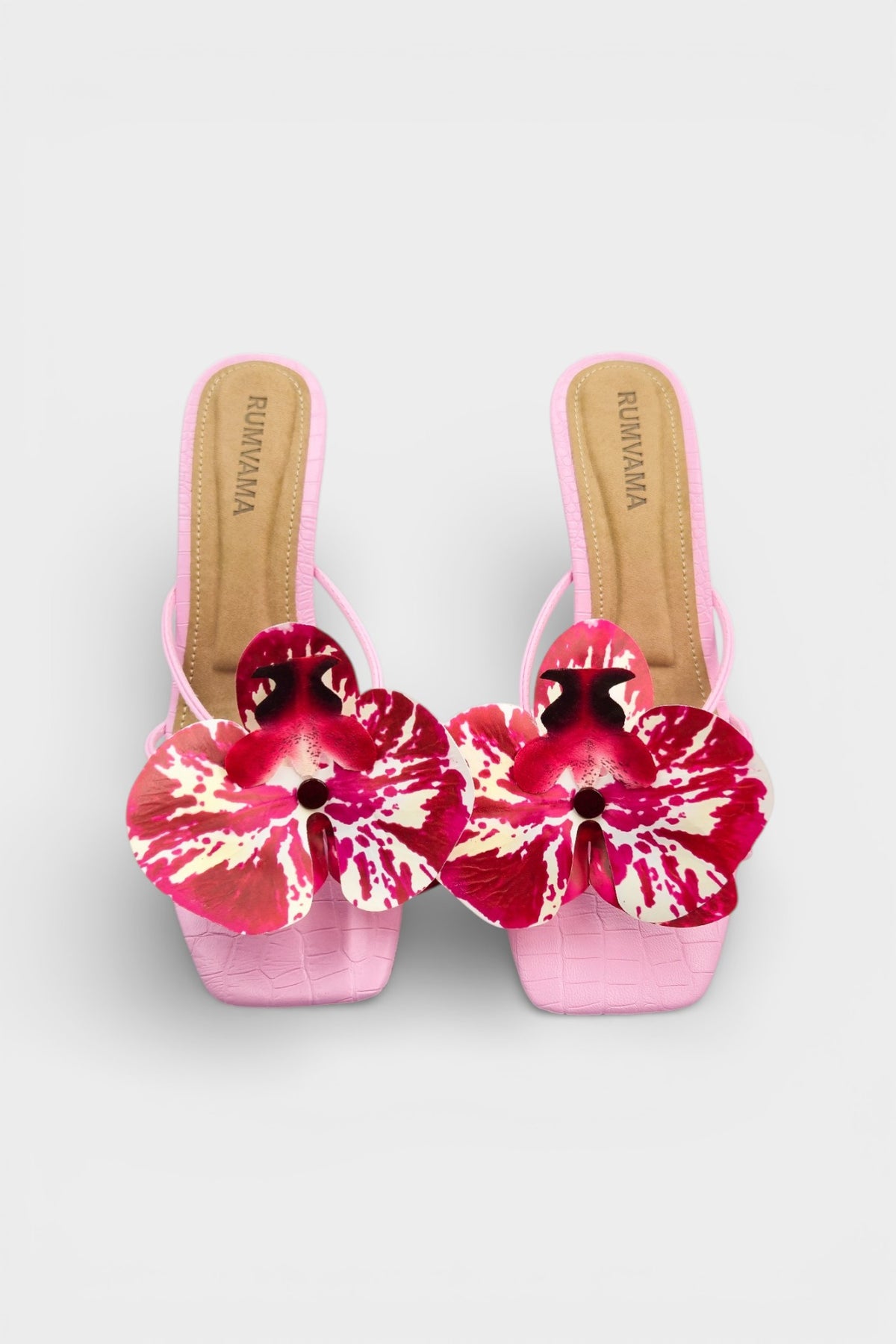 Pink slip-on sandal heels with printed orchid flower accents.