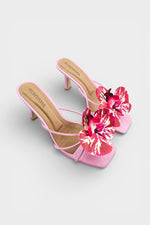 Pink slip-on sandal heels with printed orchid flower accents.