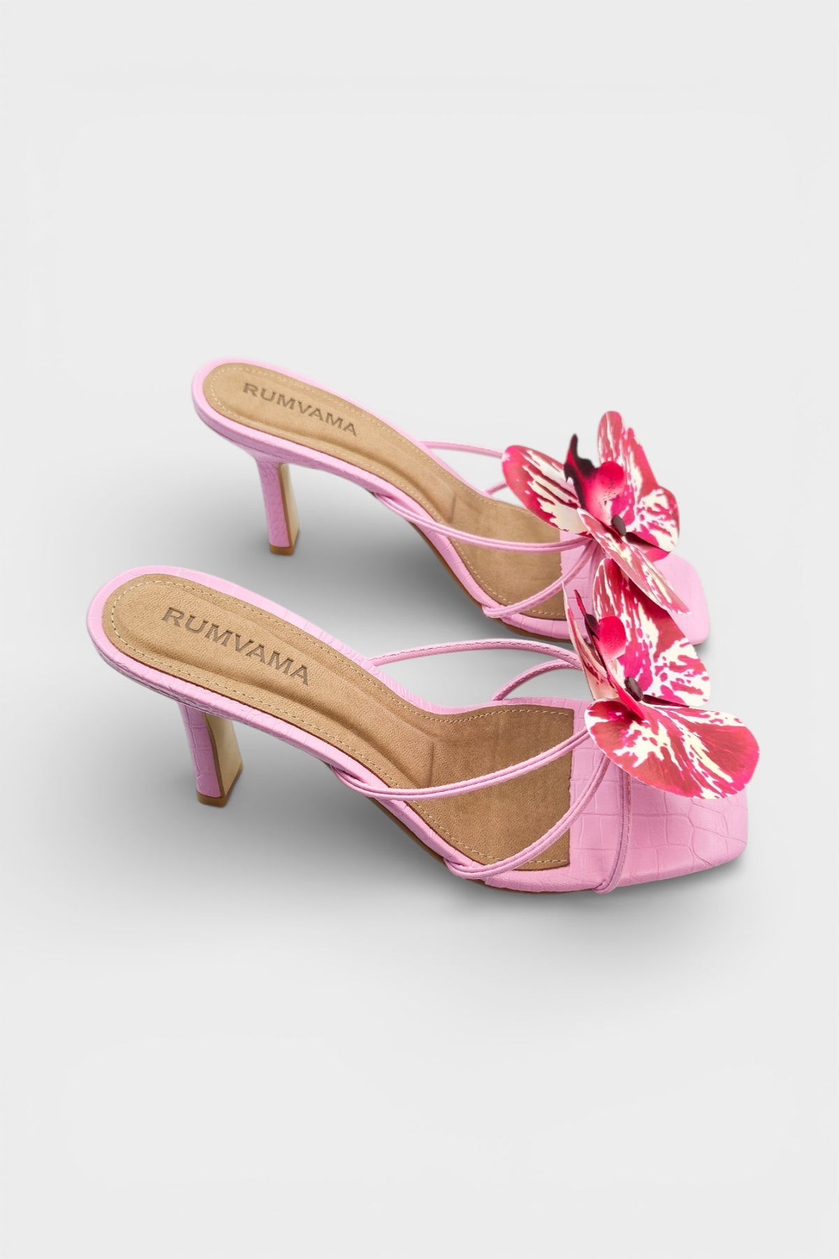 Pink slip-on sandal heels with printed orchid flower accents.
