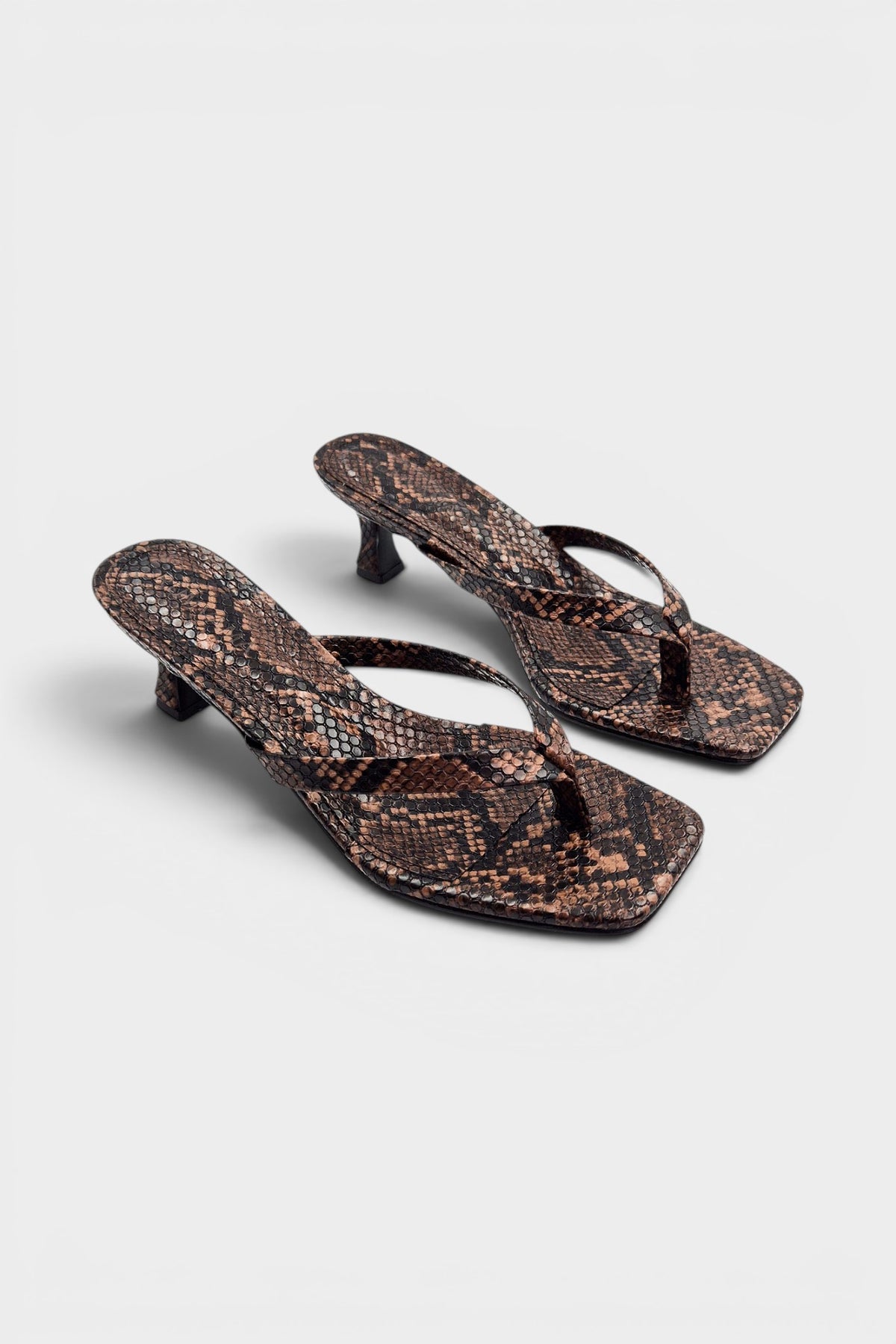 Snake print thong mule heels with matching insoles and kitten heels.