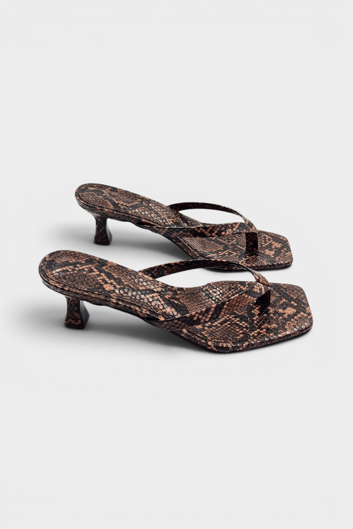 Snake print thong mule heels with matching insoles and kitten heels.