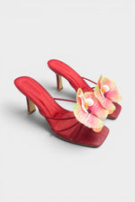 Red slip-on sandal heels with printed orchid flower accents.