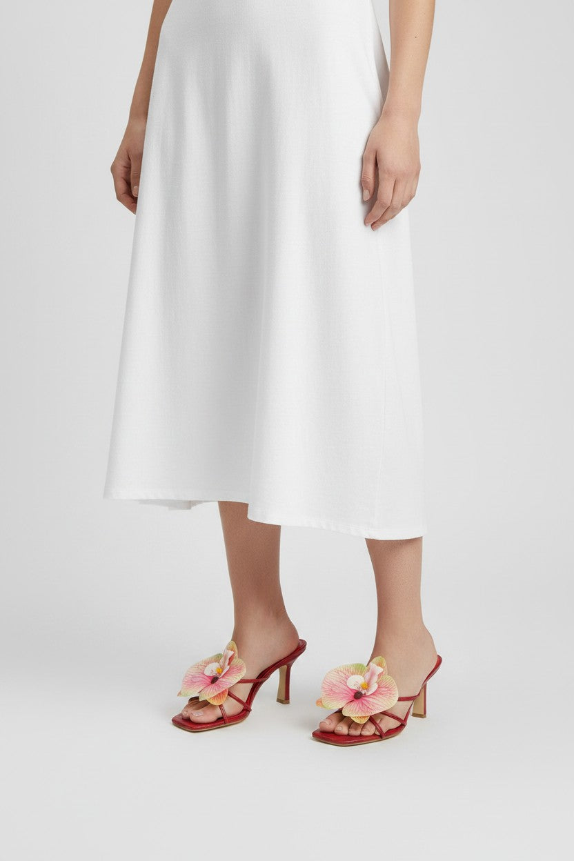 Red slip-on sandal heels with printed orchid flower accents.