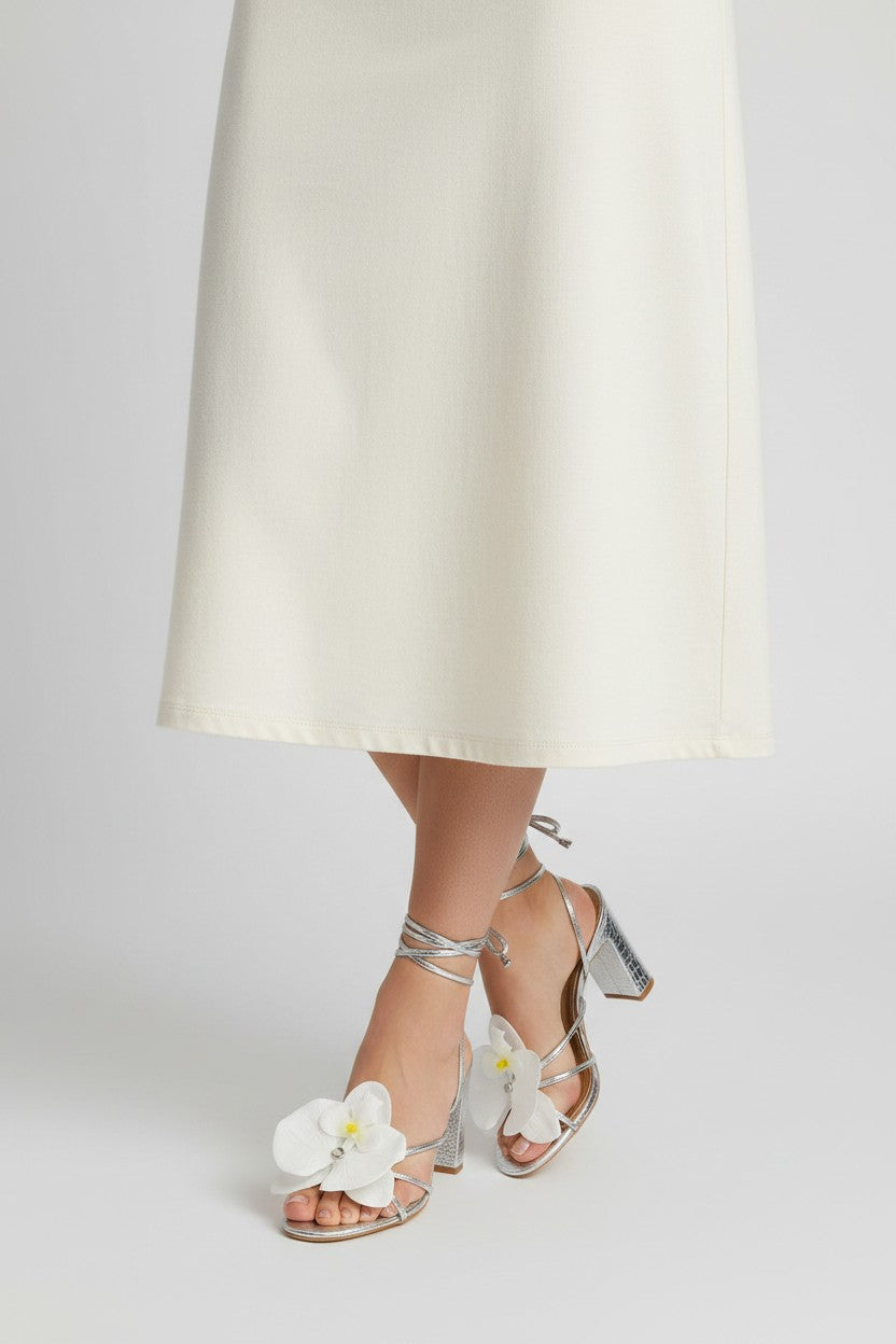 Silver slip-on sandal heels with white silk orchid flower accents.